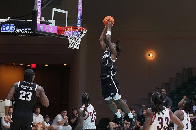 Arkansas guards Jordan Smith and Abdou Toure celebrating during an exhibition game against Carleton in the Bahamas.