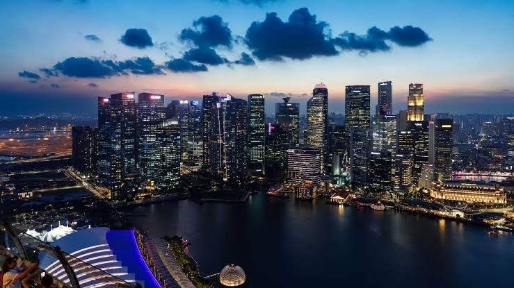 Commercial buildings in Singapore at dusk representing the nation's economic hub and financial activity.