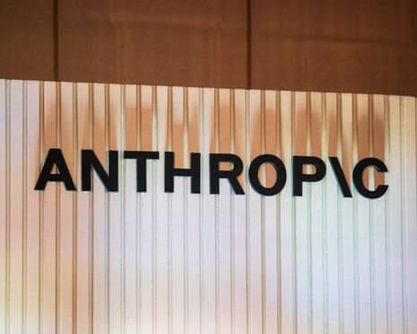 Signage for Anthropic displayed on a glass wall inside a modern corporate office setting.