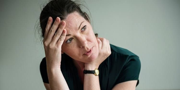 A person sitting in a therapy setting describing their life story, highlighting the connection between narrative and health.