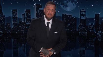 Jelly Roll sitting at the Jimmy Kimmel Live desk during his guest hosting segment to discuss his political views.