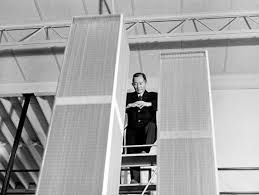 Minoru Yamasaki poses with a model of the World Trade Center twin towers during his design process.