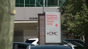 Hospital signage at an emergency department entrance in Manchester during daylight hours.