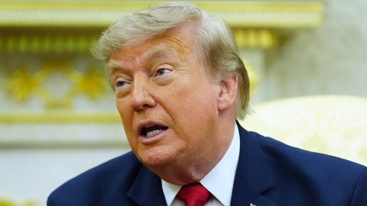 President Trump speaking at a podium during a press event regarding industrial regulatory relief.