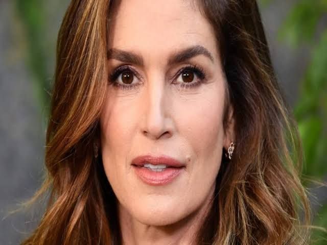 Cindy Crawford posing for a professional portrait showcasing her fitness-focused lifestyle and iconic style.