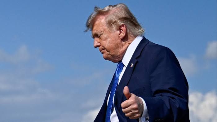 Donald Trump speaking to reporters during an outdoor press event regarding his foreign policy stance on the Middle East.