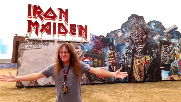 Steve Harris stands among rock memorabilia and historic band exhibits at the Eddfest festival site in Knebworth Park.