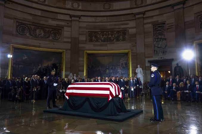 U.S. Capitol Police honor guard stands watch over the flag-draped casket of Senator Lindsey Graham in the Capitol Rotunda.