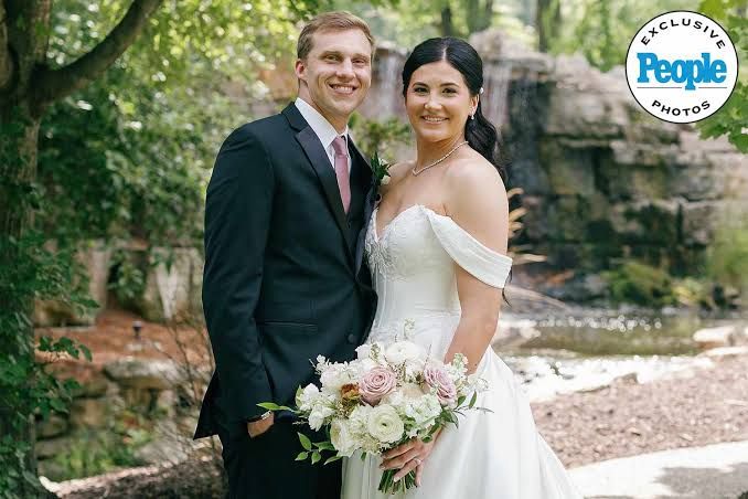 Megan Gustafson and David DiLeo pose together at their garden wedding in Iowa.