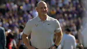 Vanderbilt head coach Clark Lea speaking at the podium during SEC Media Days in Tampa.