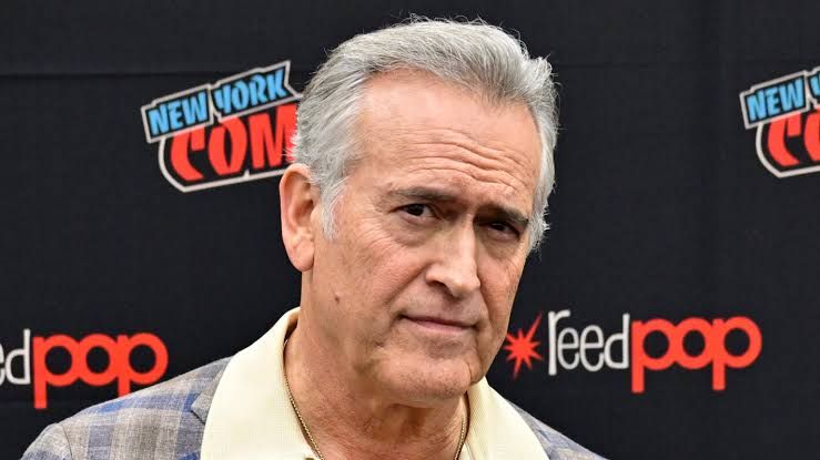 Bruce Campbell posing for a professional portrait, reflecting on his career and health status during a recent interview.