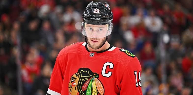 Chicago Blackhawks captain Jonathan Toews skating on the ice in his team uniform during an NHL game.