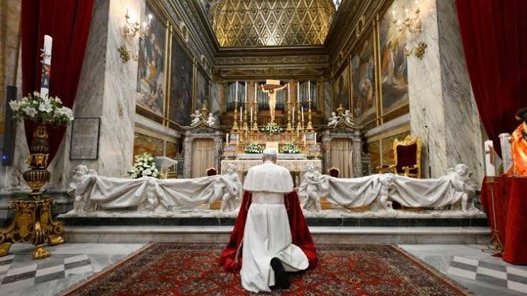 Pope Leo XIV praying at the altar in the Basilica of the Mother of Good Counsel in Genazzano during his official visit.