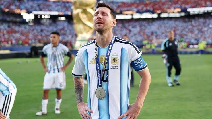 Lionel Messi appearing emotional on the pitch at MetLife Stadium after Argentina's loss to Spain in the World Cup final.