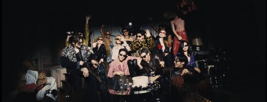 BTS music group members appear in a cinematic scene from their music video for the song Normal.