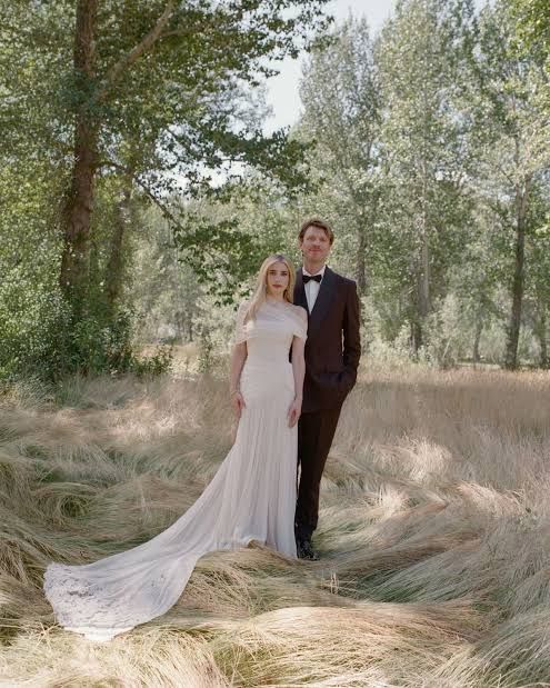 Emma Roberts and partner Cody John posing outdoors during their mountainside wedding ceremony in Sun Valley, Idaho.