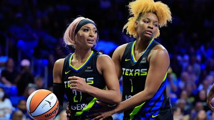 DiJonai Carrington and NaLyssa Smith in a basketball game, highlighting their public history before recent accusations.