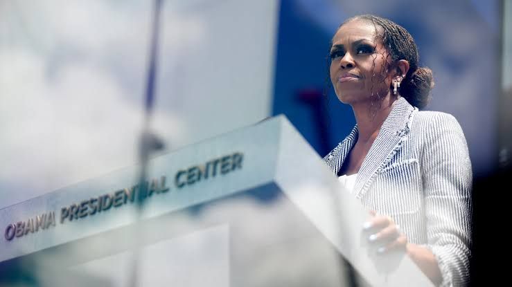 Michelle Obama speaking during a live podcast taping at the Essence Festival of Culture in 2026.