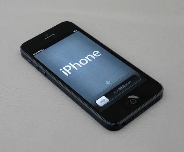 An Apple iPhone and a Samsung Galaxy phone displayed side-by-side to illustrate the shift in global market share.