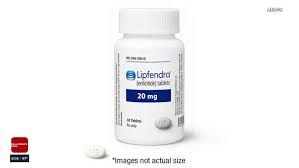 A clinical close-up of the new Lipfendra medication pill and a heart health medical chart.