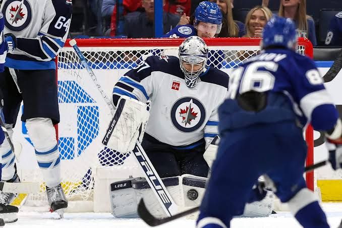 Winnipeg Jets goaltender Connor Hellebuyck skating on the ice during an NHL regular season game.