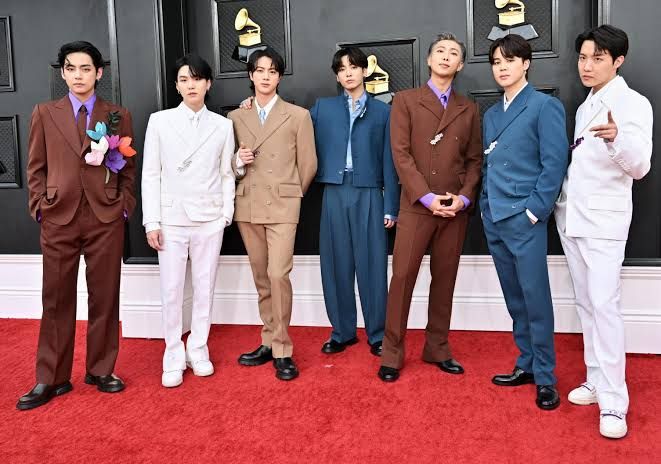 BTS members standing together during a public appearance as the group confirms they will boycott the 2027 Grammy Awards.