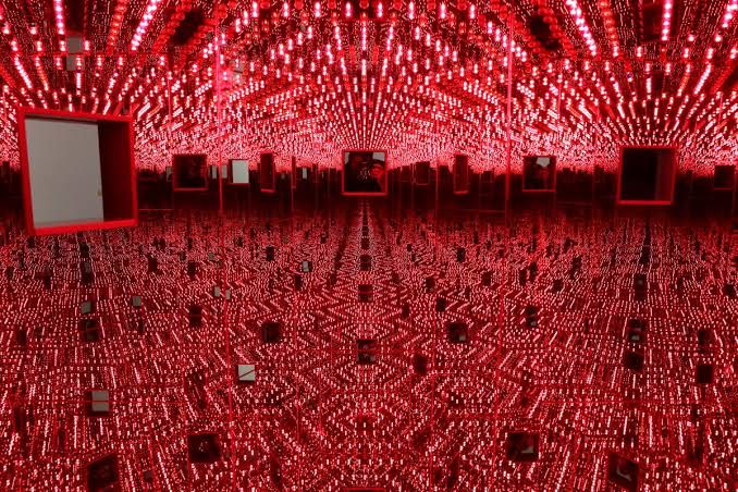 Visitors observing Yayoi Kusama's Infinity Mirror Room at The Broad museum in Los Angeles.