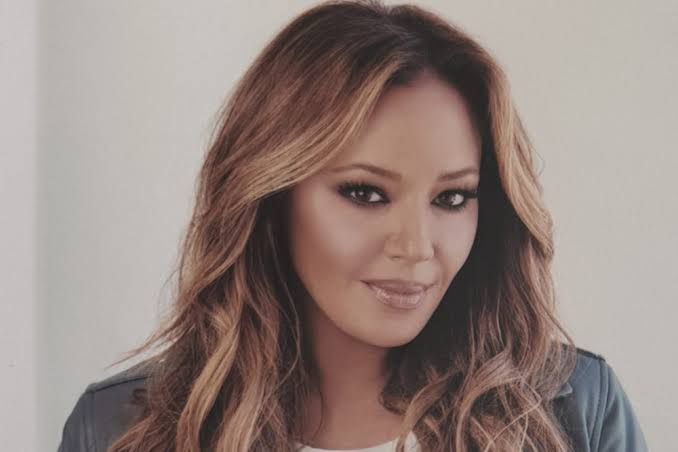 Leah Remini posing for a promotional portrait during the announcement of her new role on RHOBH Season 16.