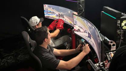 NHL players interacting with a professional racing simulator during the North American Player Media Tour in Las Vegas.