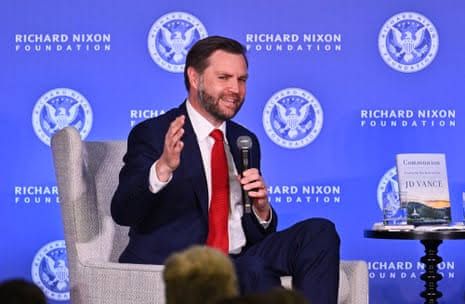JD Vance holding a microphone while speaking at the Richard Nixon presidential library during a book event.