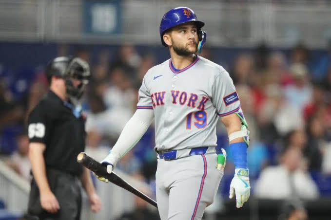 New York Mets player in uniform standing on the field at Citi Field during a Major League Baseball game.