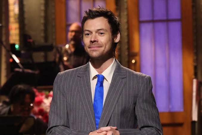 Harry Styles speaking on stage during a monologue at an event in March 2026.