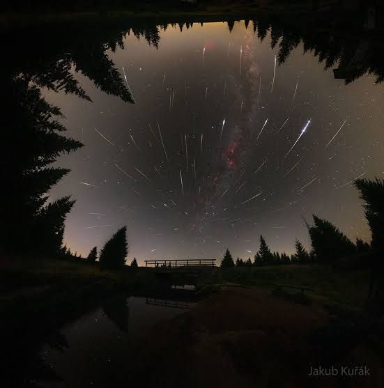 Streaks of light from the Perseids meteor shower emanate from a central point above a bridge in Jizerka, Czech Republic.