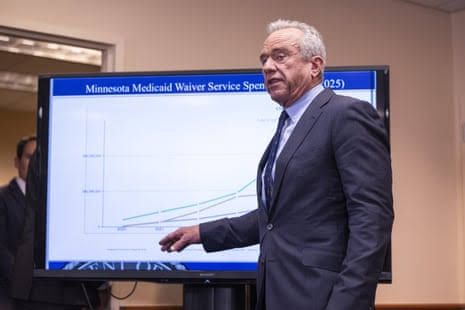 Robert F. Kennedy Jr. speaks at a podium in front of a digital chart regarding Medicaid fraud during a press conference.