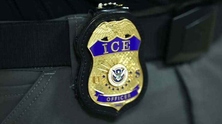 An ICE agent badge attached to a uniform at the Jacob K. Javits Federal Building.