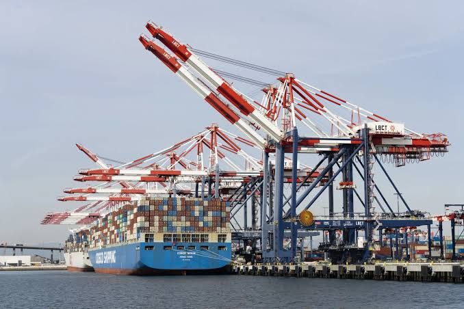 Shipping containers stacked at the Port of Long Beach during a busy day of operations.