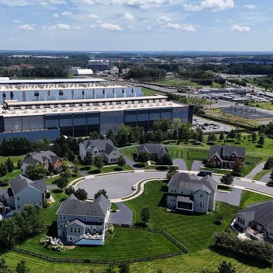 An aerial view of a large data center construction site located in the middle of open farmland.