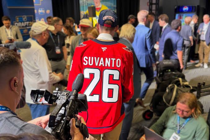 Washington Capitals front office personnel discussing player prospects during their 2026 NHL draft room simulation.