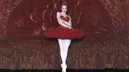 Pop artist ADÉLA posing with her pink hair in a promotional shot for her debut album PRIMA and upcoming tour.