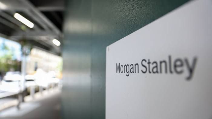 Morgan Stanley office sign in front of a modern financial district building.