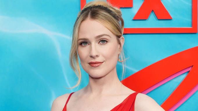 Evan Rachel Wood standing on a red carpet while discussing her absence from the new Practical Magic sequel.