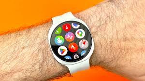 Close-up of a Samsung Galaxy Watch 9 on a wrist next to a Google Pixel Watch 5 for comparison.