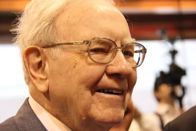 Warren Buffett speaking at an event, illustrating his role as a long-term investment strategist.