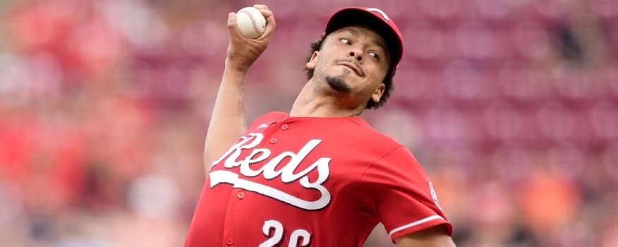 Cincinnati Reds pitcher Chase Burns delivering a fastball during a professional baseball game.