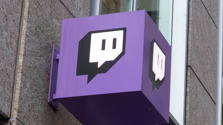 Twitch content creator interface showing a live broadcast screen and active chat panel on a computer monitor.