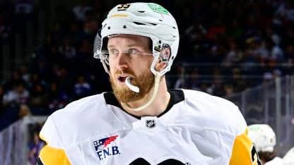 Anthony Mantha wearing a Pittsburgh Penguins jersey while looking toward the ice during a game.