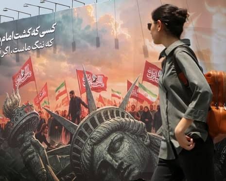 A mural of a toppled Statue of Liberty in Tehran, Iran, highlighting current geopolitical tensions.