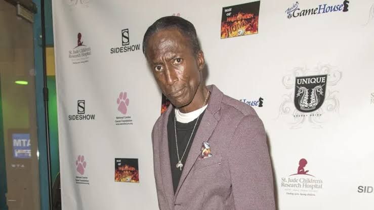 Michael Wright stands on a red carpet while promoting a film project.