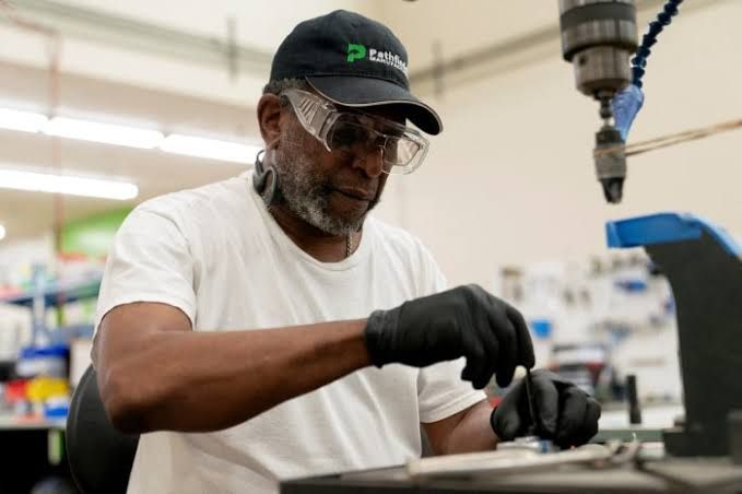 A small business owner checking inventory in a warehouse during the June economic sentiment index reporting period.