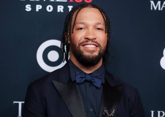 Jalen Brunson standing on a basketball court wearing his New York Knicks uniform.